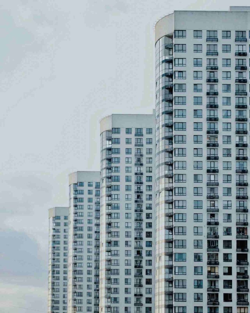 Curved white residential towers seen from below