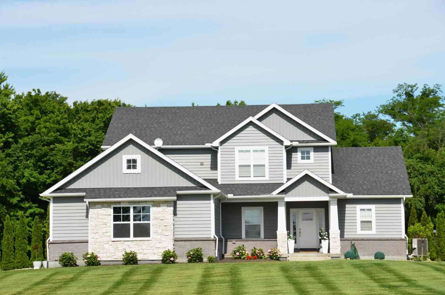 Gray modern farmhouse with white trim and a covered porch